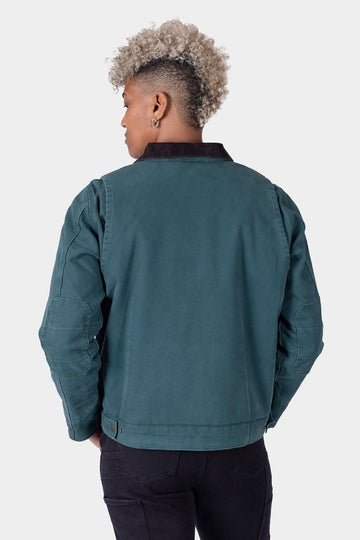 Back view of woman wearing the Lodge Green Old School Trucker Canvas Work Jacket by Dovetail Workwear, showing corduroy collar and reinforced elbow construction