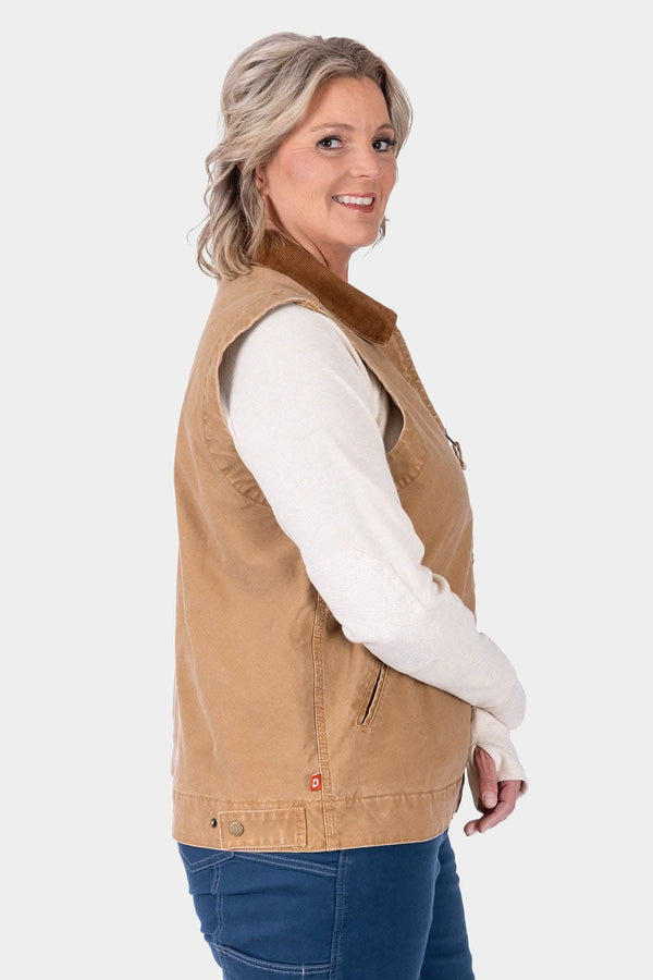Back view of a woman wearing the Dovetail Workwear Old School Trucker Vest in Vintage Brown over a cream long-sleeve shirt, paired with blue jeans
