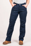 Woman wearing Dovetail Workwear Anna Taskpant in Uniform Navy Canvas with relaxed straight leg, crotch gusset, and knee pad slots, paired with brown work boots
