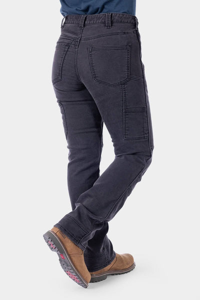 Back view of a woman wearing Dovetail Workwear's Britt Utility HOTSWAP™ Pant in Black Thermal Denim, showcasing cargo-style pockets and straight-leg fit with thermal insulation