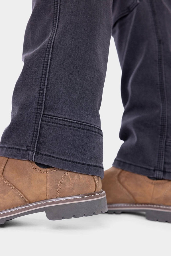 Close-up of cuffs of Britt Utility HOTSWAP™ Pant in Black Thermal Denim showing double knees and straight leg fit. Insulated work pants 40% warmer for cold weather.