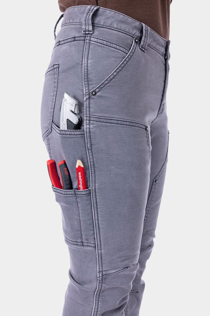 Close-up of utility pockets on grey Britt Utility HOTSWAP™ Pants holding tools, highlighting functional design for active work environments.