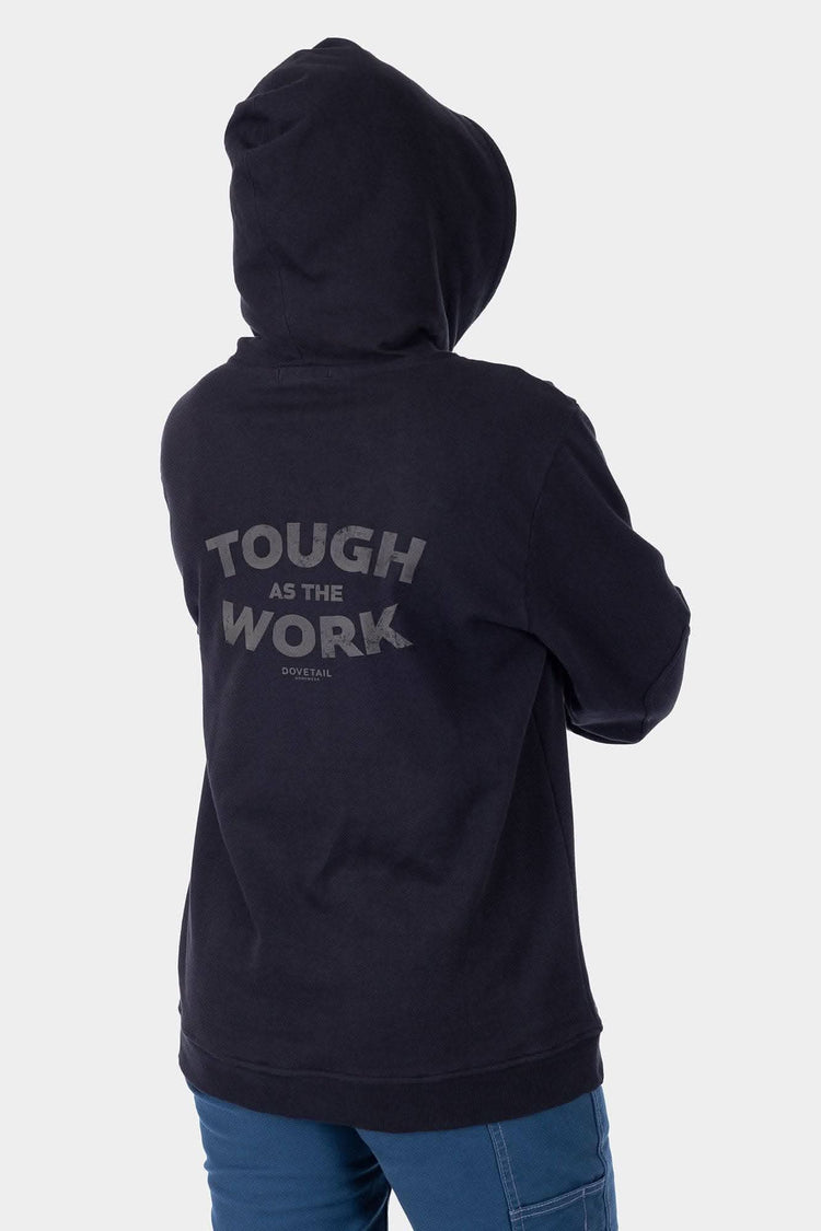 Back view of a woman wearing the Dovetail Workwear GO TO™ Graphic Hoodie in Carbon Black, featuring graphic text and reinforced elbows