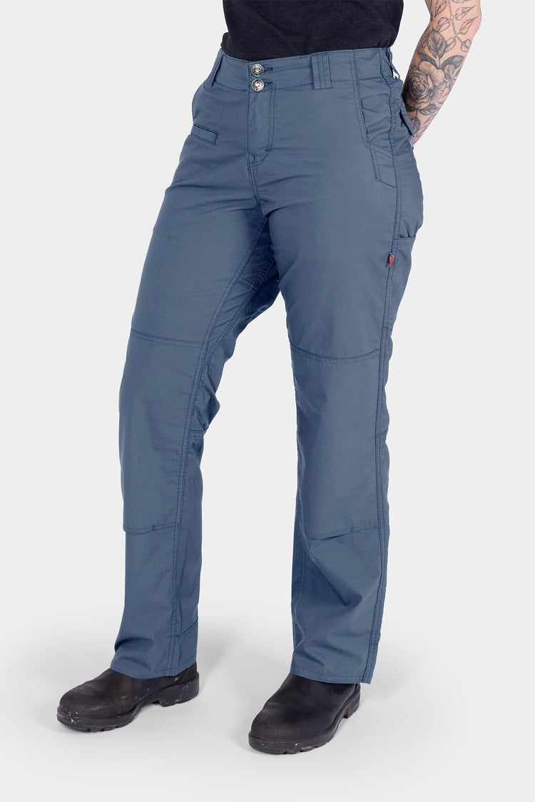 Dovetail Workwear Day X COOLSWAP™ Pant in Dovetail Blue worn by a woman, showcasing the relaxed straight leg fit, reinforced knee with kneepad slot, and functional pockets designed for work and outdoor activities