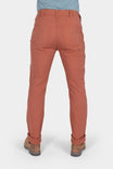 Back view of a woman wearing Dovetail Workwear GO TO™ Stretch Canvas Pant in Terracotta, showing reinforced knees and nested pockets with cuffed hem