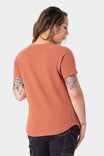 Back view of a woman wearing the Dovetail Workwear Old School Summer Henley in Terracotta, showing the lightweight cotton blend waffle knit fabric and short sleeves