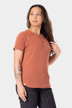 Terracotta Old School Summer Henley Shirt by Dovetail Workwear worn by a woman, showcasing the lightweight cotton blend waffle knit fabric and button-front placket detail