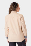 Back view of a woman wearing the Dovetail Workwear Givens Long Sleeve Summer Work Shirt in Ecru White, showing the button chest pocket and contrast inner cuffs
