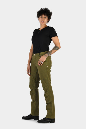 Woman wearing Dovetail Workwear GO TO™ Stretch Canvas Pant in Kelp Green with black t-shirt, showcasing the straight leg fit and tool loop detail