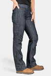 Side view of a woman wearing Dovetail Workwear's DX Bootcut Pant in FR Denim, showcasing the bootcut silhouette, cargo pockets, and articulated knee design in indigo denim.