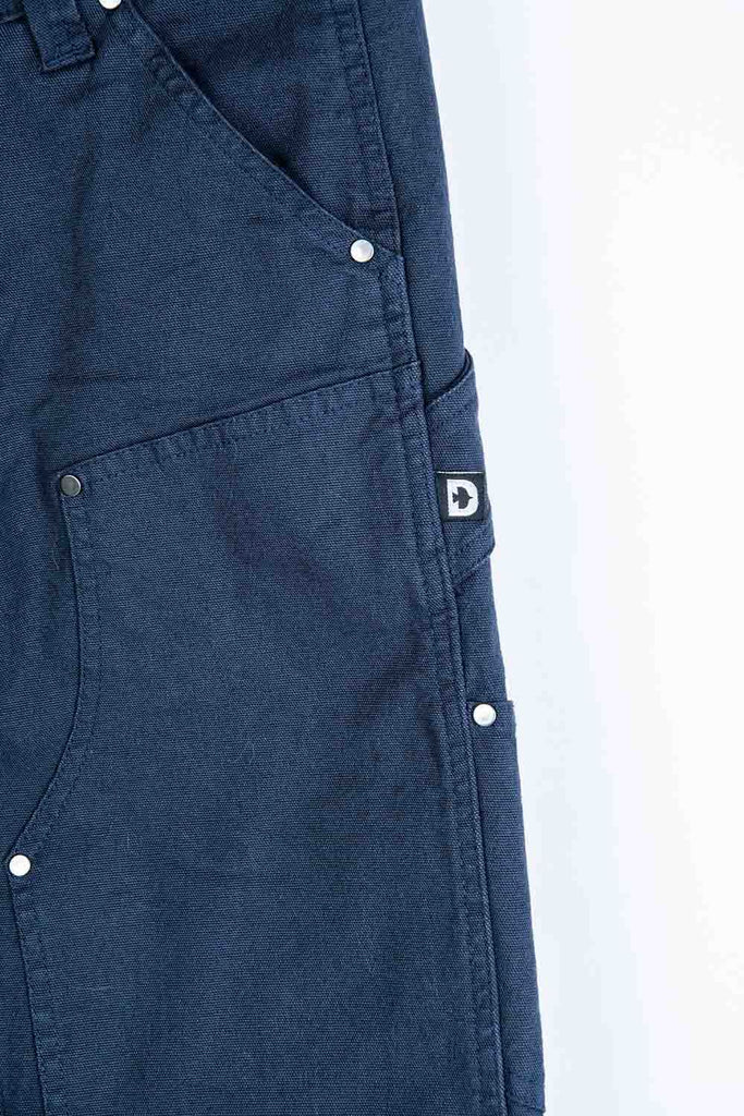 Detail view of the Anna Taskpant in Uniform Navy Canvas by Dovetail Workwear, showing nested pocket construction, Hip Slot™ Tool loop placement on the leg, and reinforced knee.